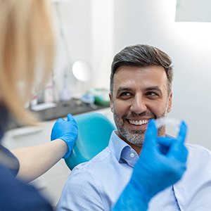 Delray Beach patient talking to dentist about Invisalign