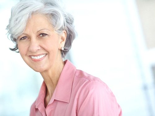 Portrait of smiling older woman in pink blouse