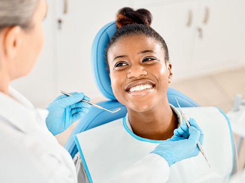 Happy patient looking at her dentist