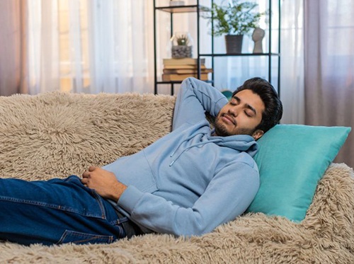 Man relaxing on his sofa at home