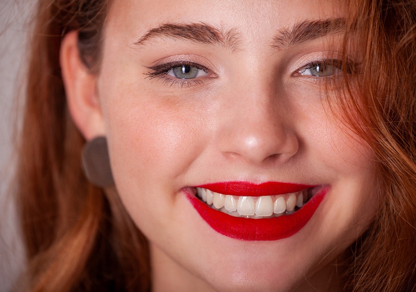 A smiling woman with bright red lips