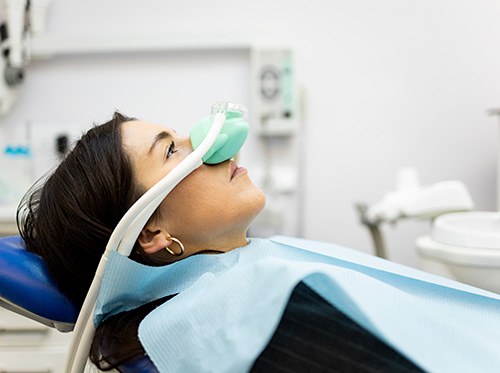 young woman with a nasal mask on for nitrous oxide sedation