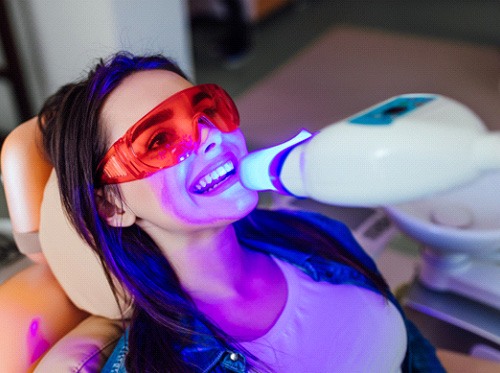 Woman in dental chair receiving professional teeth whitening in Delray Beach