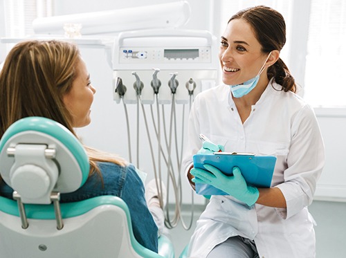 a dentist speaking with a patient