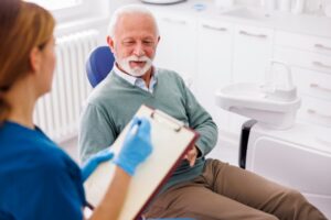 Man consulting with dentist.